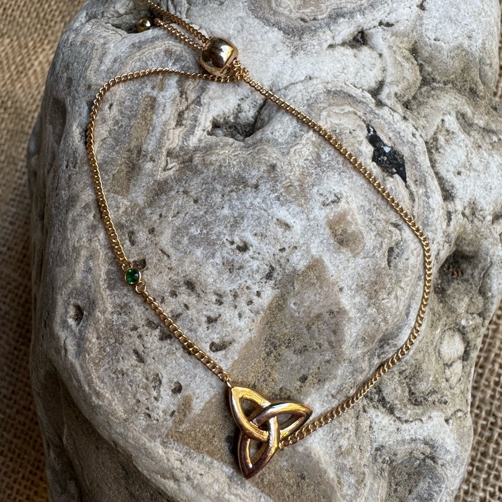 Rose gold colored celtic knot adjustable bracelet with small green stone